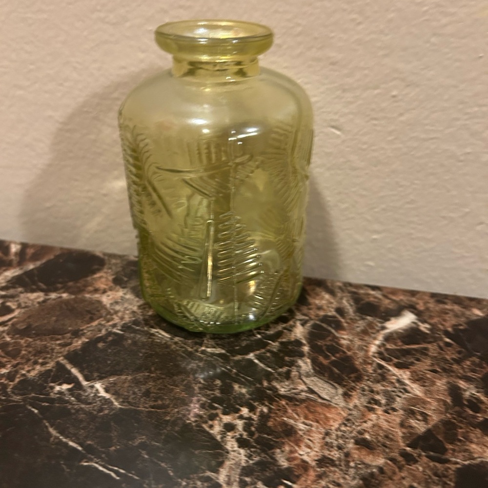 yellow iridescent glass vase with a leaf etching